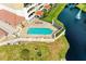 Relaxing pool area with patio furniture near pond and building at 501 Haben Blvd # 806, Palmetto, FL 34221