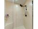 Walk-in shower featuring tiled walls, a built-in corner seat, and a shower head with a hose at 501 Haben Blvd # 806, Palmetto, FL 34221