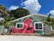 Flamingo house exterior with lush landscaping and palm trees at 5127 27Th S Ave, Gulfport, FL 33707