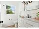 Bright bathroom featuring granite counters, vanity, and decorative lighting at 523 Deville E Dr, Largo, FL 33771