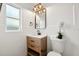Modern bathroom features wooden vanity, quartz counters, and a stylish light fixture at 523 Deville E Dr, Largo, FL 33771