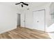 Bedroom featuring neutral walls, wood-look floors, ceiling fan, and closet at 523 Deville E Dr, Largo, FL 33771