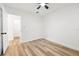 Well-lit bedroom with wood-look flooring, a ceiling fan, and closet space at 523 Deville E Dr, Largo, FL 33771