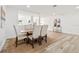 Bright dining room featuring a table set for six and light wood flooring at 523 Deville E Dr, Largo, FL 33771