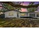 Beautiful one-story home with a gray roof, white exterior, and dark gray garage door at 523 Deville E Dr, Largo, FL 33771