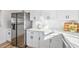 Bright kitchen with stainless steel appliances, white cabinets and countertops at 523 Deville E Dr, Largo, FL 33771
