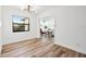 A living room features a modern light fixture and light-colored wood flooring at 523 Deville E Dr, Largo, FL 33771