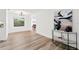 A living room features a modern light fixture, art and light-colored wood flooring at 523 Deville E Dr, Largo, FL 33771
