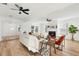 Bright living room with light-toned wood floors, fireplace, and comfortable seating, illuminated by natural light at 523 Deville E Dr, Largo, FL 33771