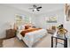 Main bedroom features natural light, ceiling fan, and neutral decor elements at 523 Deville E Dr, Largo, FL 33771