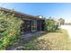 Landscaped backyard with screened patio at 7360 Ulmerton Rd # 2B, Largo, FL 33771