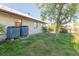 Spacious backyard with AC units and mature tree providing shade at 937 Bunker View Dr, Apollo Beach, FL 33572
