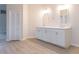Double vanity bathroom with white cabinets and quartz countertop at 937 Bunker View Dr, Apollo Beach, FL 33572