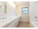 Bathroom featuring a double vanity and a bathtub at 937 Bunker View Dr, Apollo Beach, FL 33572