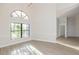 Bright dining area with hardwood floors and arched window at 937 Bunker View Dr, Apollo Beach, FL 33572