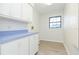 Laundry room with white cabinets and light blue countertop at 937 Bunker View Dr, Apollo Beach, FL 33572