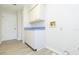 Bright laundry room with white cabinets and light grey vinyl flooring at 937 Bunker View Dr, Apollo Beach, FL 33572