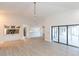 Living room with vaulted ceiling, brick fireplace and access to lanai at 937 Bunker View Dr, Apollo Beach, FL 33572