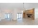 Open living room with brick fireplace, vaulted ceiling and sliding glass doors at 937 Bunker View Dr, Apollo Beach, FL 33572