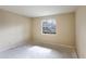 Simple bedroom with large window and an open closet at 100 Glennes Ln # 108, Dunedin, FL 34698