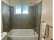 Bathroom with shower/tub combo and tile surround at 10104 45Th N Way, Pinellas Park, FL 33782