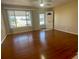 Spacious living room with hardwood floors and view of street at 10104 45Th N Way, Pinellas Park, FL 33782