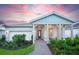 Attractive single-story home with a covered porch and well-manicured landscaping at 10157 Beachwalk Dr, Englewood, FL 34223