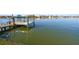 Private dock with reflection on calm water, showcasing waterfront property at 10208 Tarpon Dr, Treasure Island, FL 33706