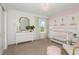 Charming Bedroom with pink accents and a crib at 10312 Cross River Trl, Parrish, FL 34219