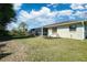 Landscaped backyard with screened porch at 11339 Gulfstream Blvd, Port Charlotte, FL 33981