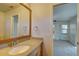 Bathroom boasts a vanity with granite countertop and a large mirror at 11339 Gulfstream Blvd, Port Charlotte, FL 33981