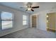 Another bedroom featuring carpet, ceiling fan and closet at 11339 Gulfstream Blvd, Port Charlotte, FL 33981