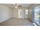 Spacious bedroom with carpet flooring, ceiling fan, and sliding glass doors at 11339 Gulfstream Blvd, Port Charlotte, FL 33981