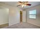 Bedroom with ceiling fan, closet, and window at 11339 Gulfstream Blvd, Port Charlotte, FL 33981