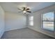 Bright bedroom with neutral walls, carpet, and two windows at 11339 Gulfstream Blvd, Port Charlotte, FL 33981