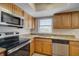 Modern kitchen with granite countertops and stainless steel appliances at 11339 Gulfstream Blvd, Port Charlotte, FL 33981