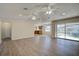 Bright living room featuring laminate wood floors and access to the back patio at 11339 Gulfstream Blvd, Port Charlotte, FL 33981