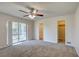 Main bedroom with carpet, ceiling fan, and access to the backyard at 11339 Gulfstream Blvd, Port Charlotte, FL 33981