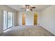 Main bedroom with carpet, ceiling fan, and en-suite bathroom at 11339 Gulfstream Blvd, Port Charlotte, FL 33981