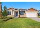 One-story home with two-toned exterior, landscaping, and a two-car garage at 12354 54Th E St, Parrish, FL 34219