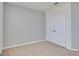 Simple bedroom with neutral walls and carpet, featuring a double door closet at 12935 Shady Fern Ln, Gibsonton, FL 33534