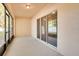 Screened porch with sliding glass doors and neutral flooring at 12935 Shady Fern Ln, Gibsonton, FL 33534