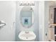 Small bathroom with white sink, oval mirror, and updated fixtures at 13747 Forest Lake Dr, Largo, FL 33771