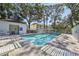 Inviting community pool with lounge chairs and surrounding trees at 13747 Forest Lake Dr, Largo, FL 33771