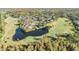 Aerial view showcasing a luxurious community near a golf course and pond at 14631 Village Glen Cir, Tampa, FL 33618