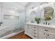 Elegant bathroom with double vanity, marble shower, and modern fixtures at 14631 Village Glen Cir, Tampa, FL 33618