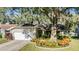House exterior with a two-car garage and landscaping at 14631 Village Glen Cir, Tampa, FL 33618