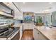 Modern kitchen with stainless steel appliances, light cabinets, and a breakfast bar at 14631 Village Glen Cir, Tampa, FL 33618