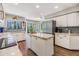 Bright kitchen features an island, stainless steel appliances, and wood-look flooring at 14631 Village Glen Cir, Tampa, FL 33618