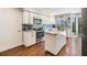 Updated kitchen with stainless steel appliances, light wood flooring and an island at 14631 Village Glen Cir, Tampa, FL 33618